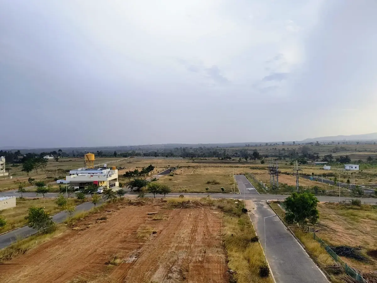 Aerial view of Flamingo Royal Splendor — open plots, paved roads and clear skies